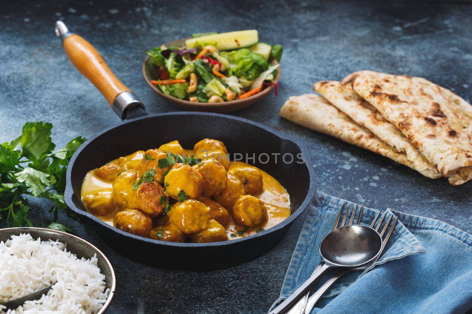 Meatballs in fragrant Indian curry sauce served with pilau rice and naan bread, selective focus by Slast20