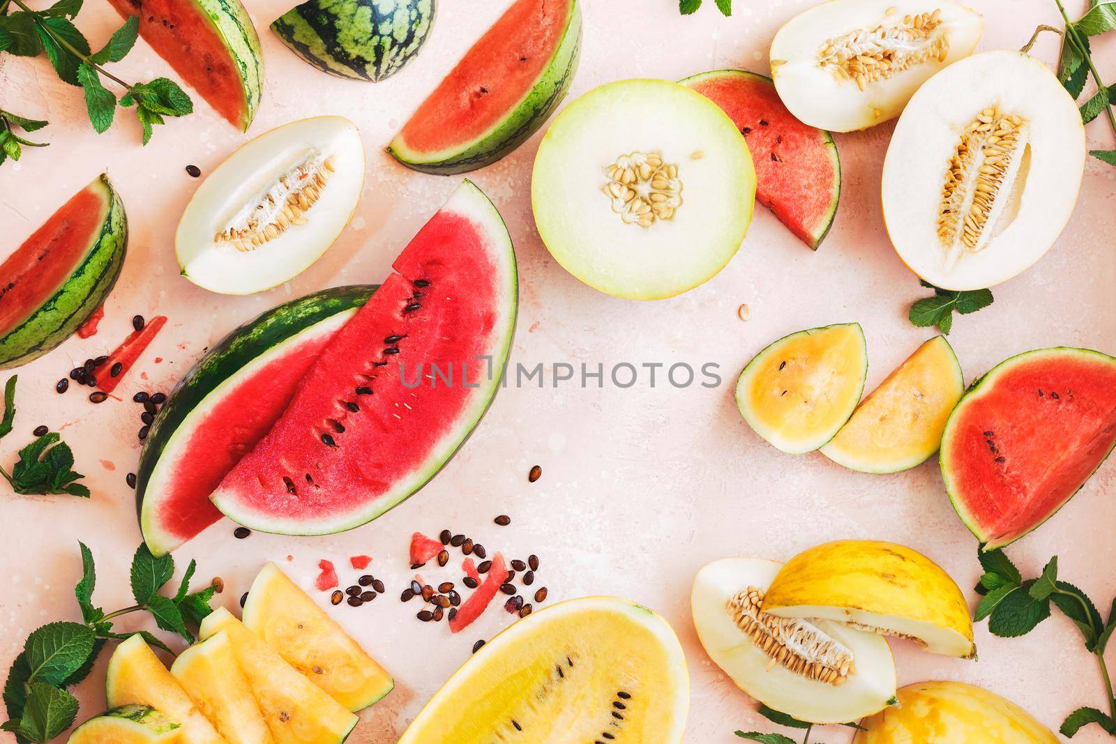 Slices and wedges of juicy watermelons and melons on rustic surface.  Top view, blank space by Slast20