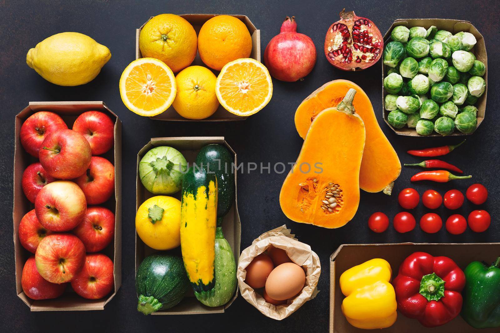 Paper boxes and bag of organic raw fruits and vegetables from the farmers market, clean eating, dieting and nutrition concept.  Top view, blank space by Slast20