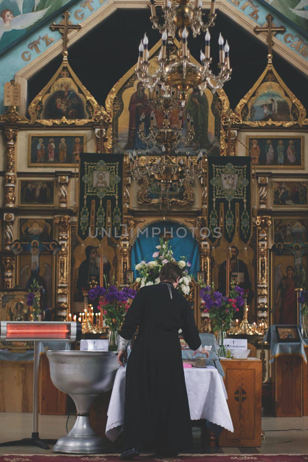 A person standing in front of icons. In a church