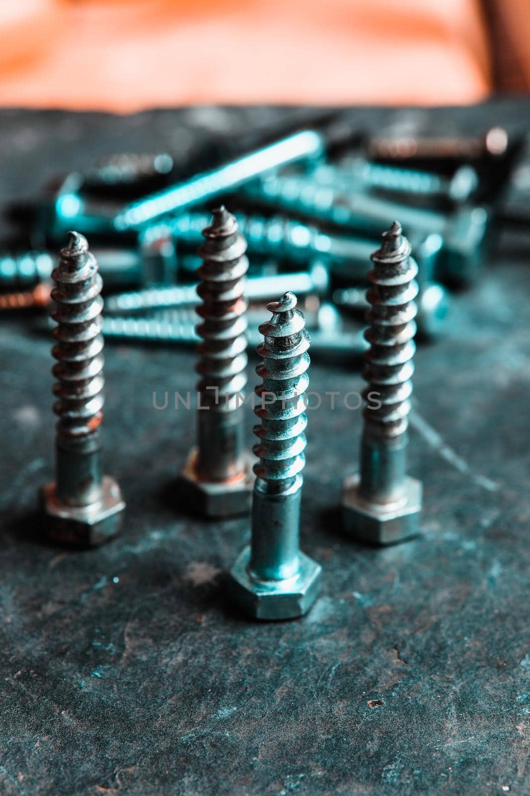 Different Kind of Screws on a table in a workshop by Weltblick