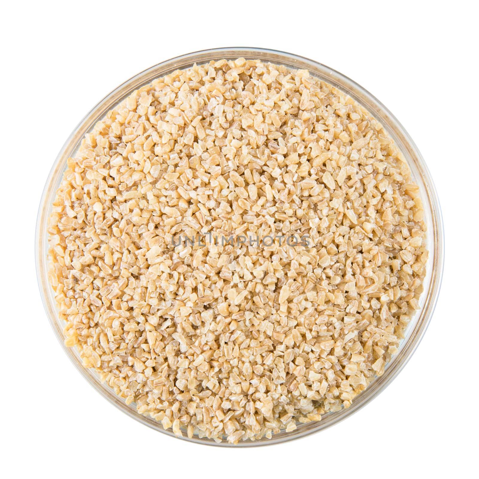 Bowl of dried bulgur wheat isolated on white background.