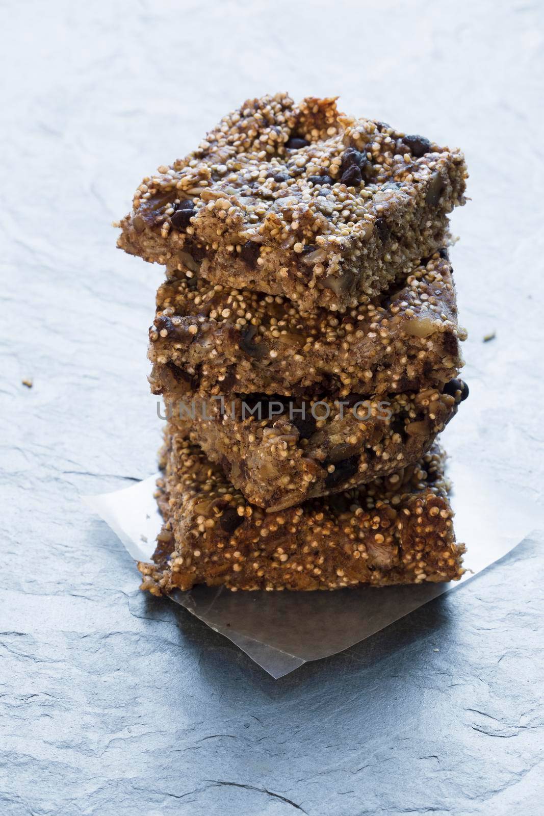 Stack of quinoa breakfast bars on stone surface