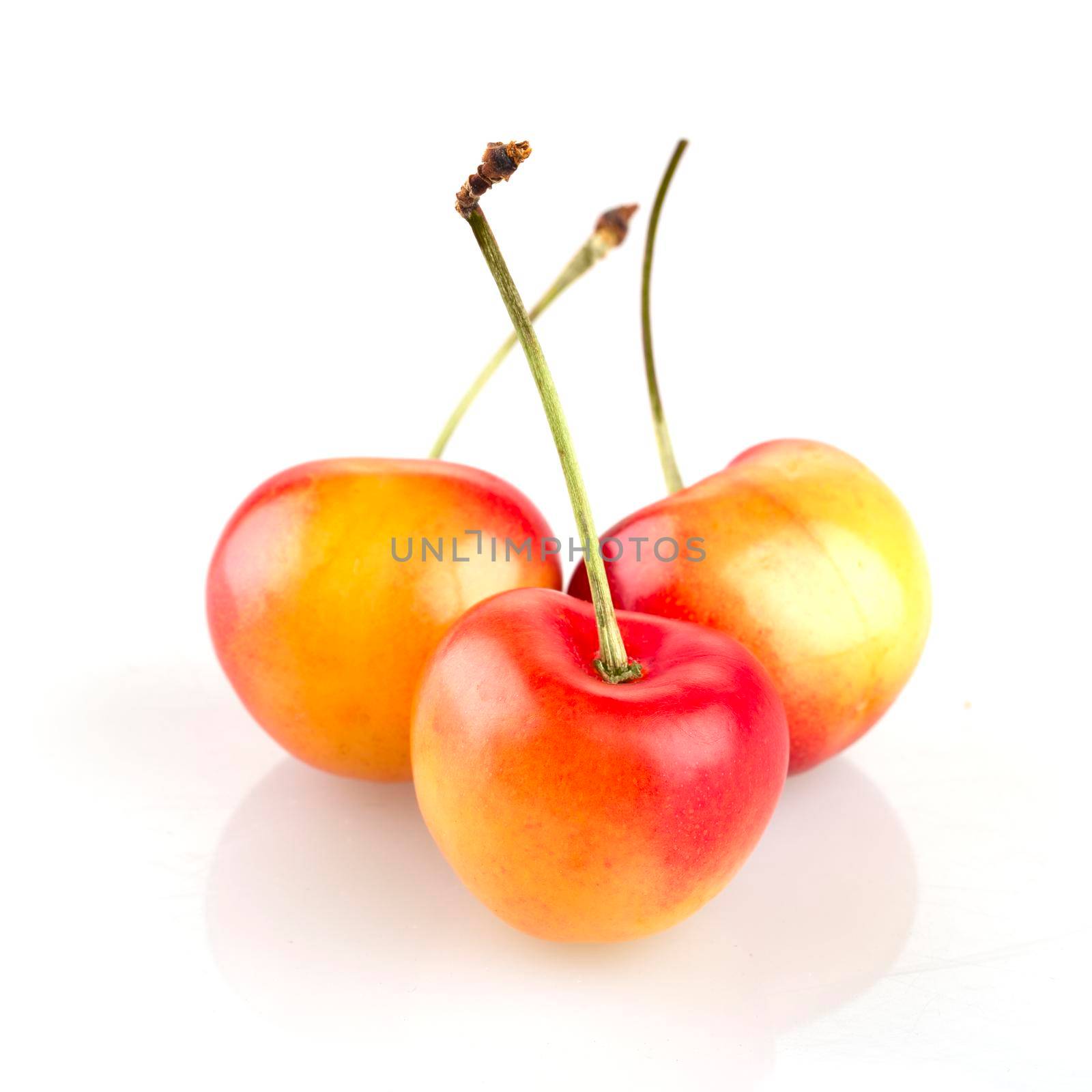 Three rainier cherries isolated on white background