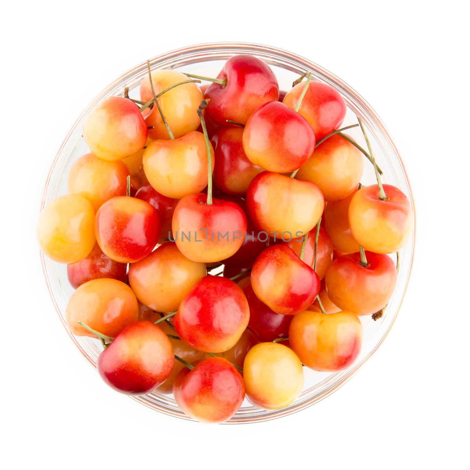 Rainier Cherries in a bowl, isolated on white and viewed from above.