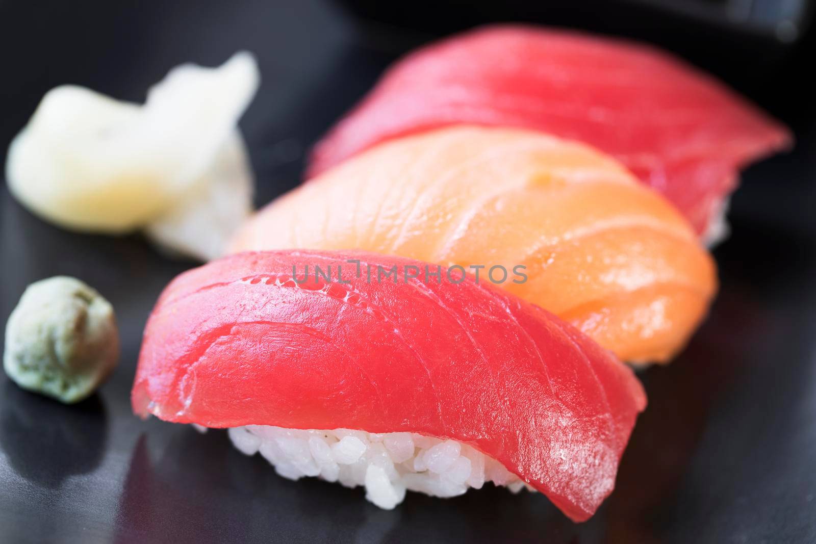 Tuna ans salmon nigiri sushi rolls with ginger and wasabi