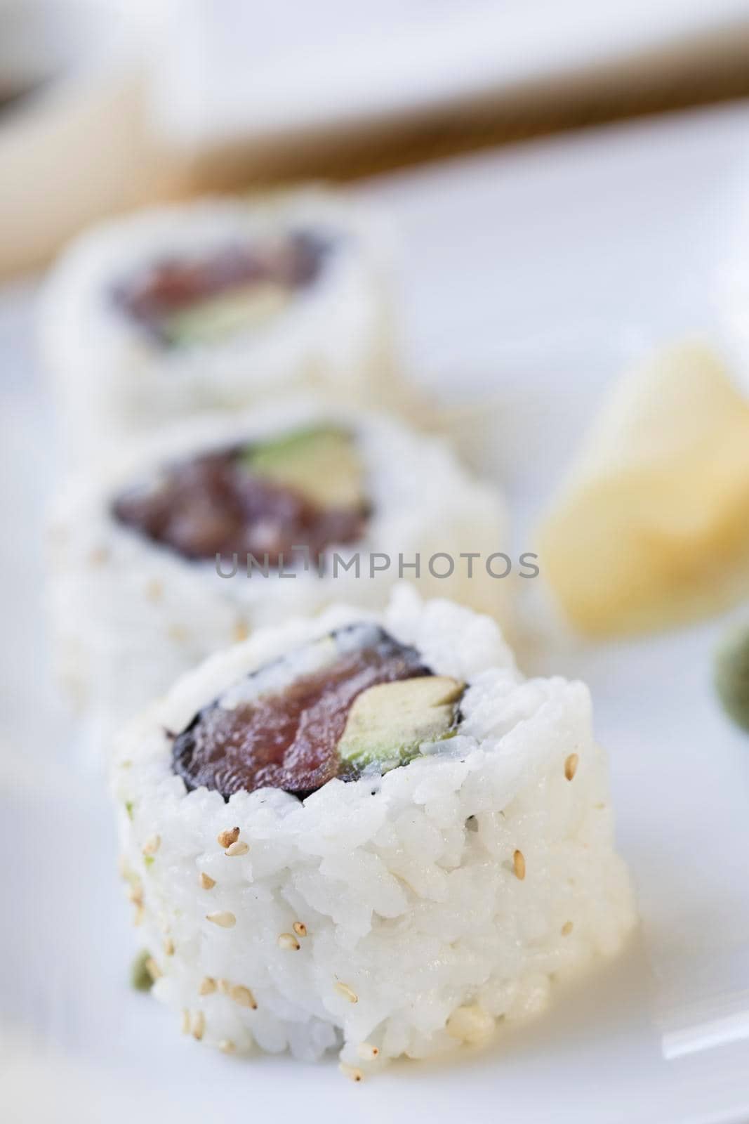 Fresh tuna and avocado uramaki sushi rolls.