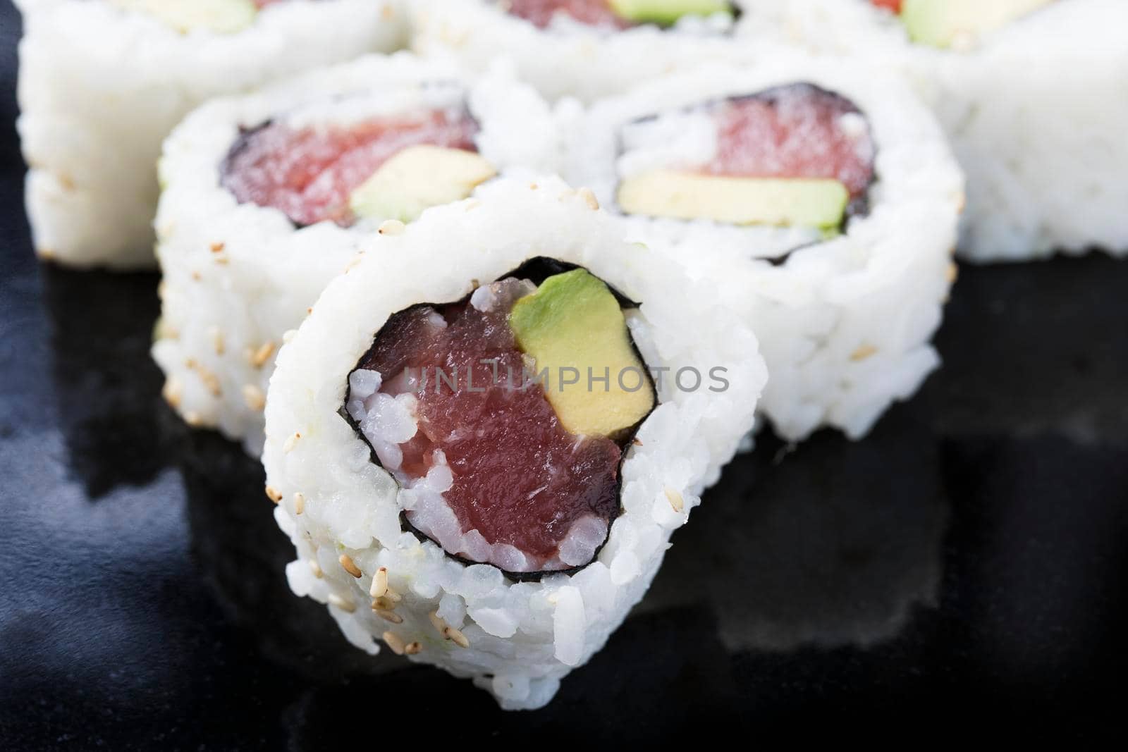 Fresh tuna and avocado uramaki sushi rolls.