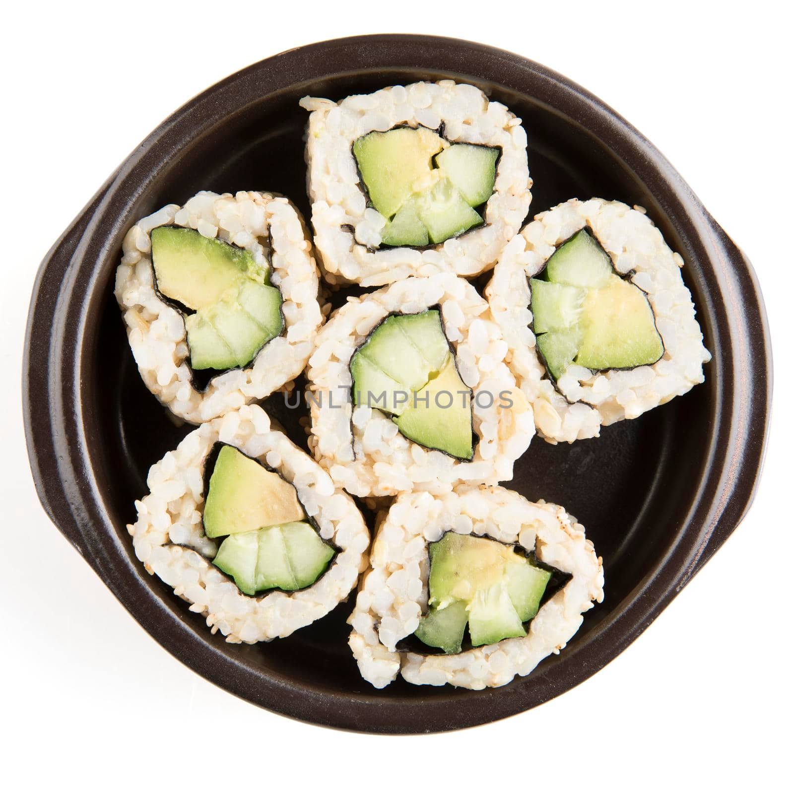 Six vegan cucumber and avocado uramaki rolls in a dish and isolated on a white background.