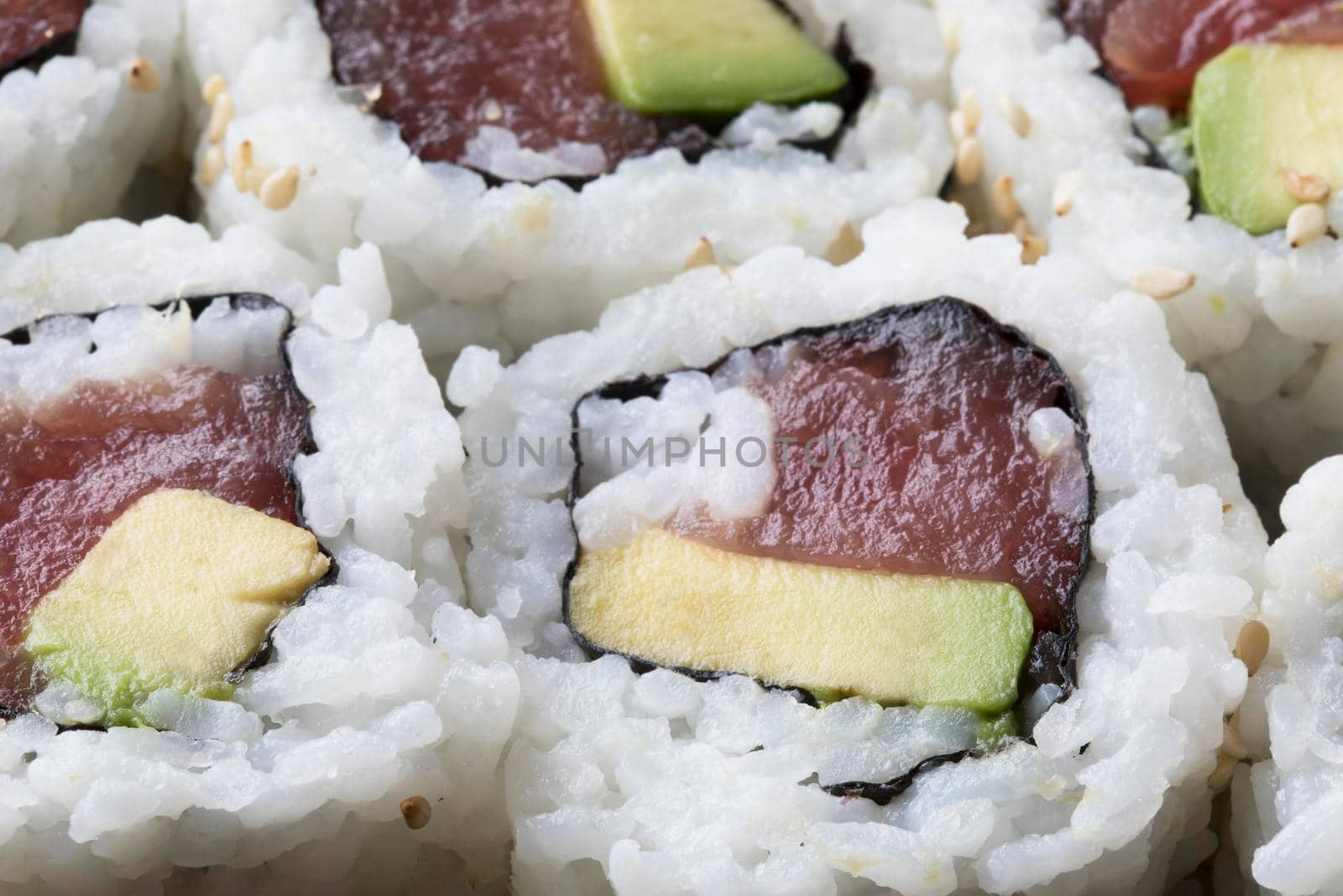 Fresh tuna and avocado uramaki sushi rolls.