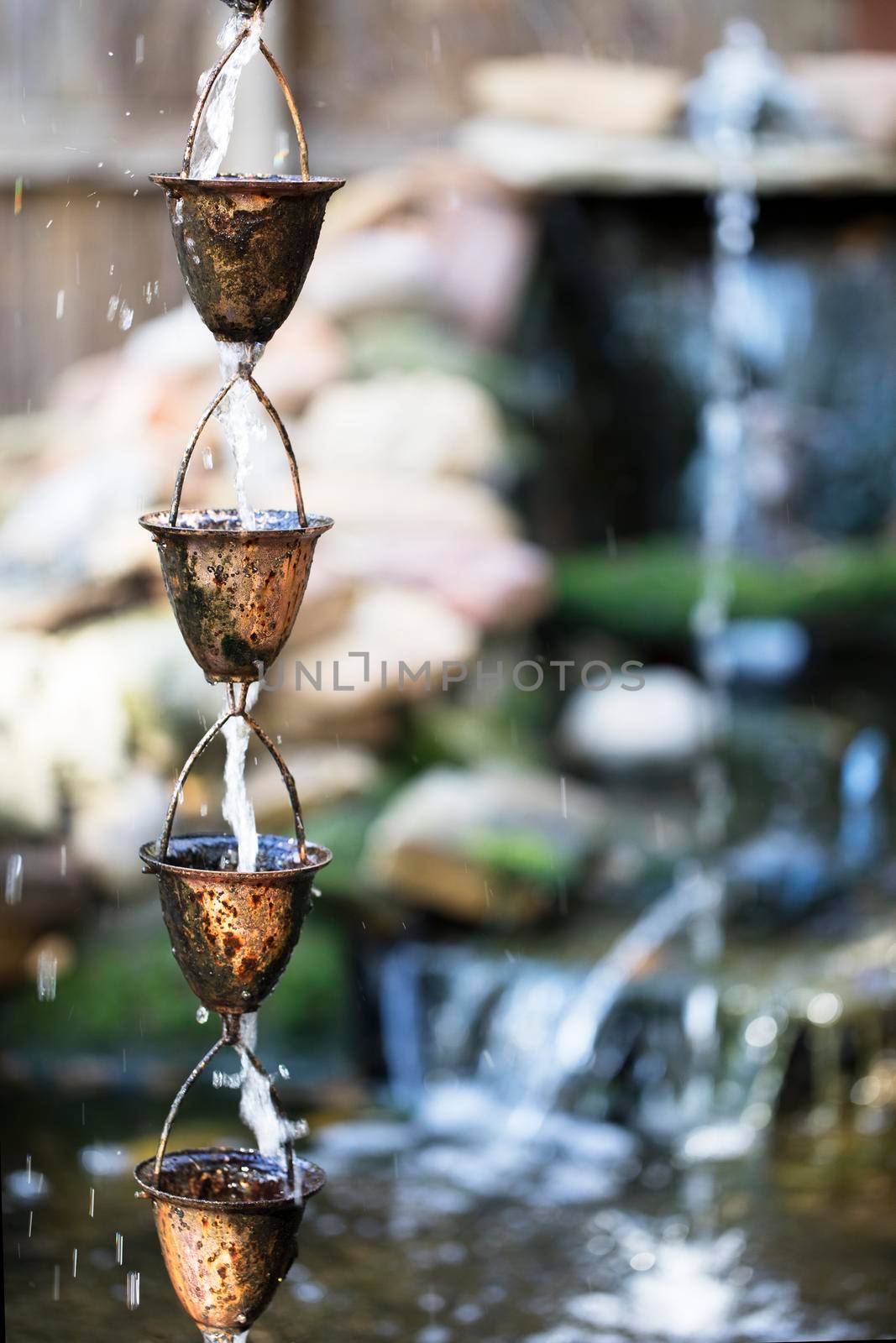 Unique copper cups used as a garden water fountain.
