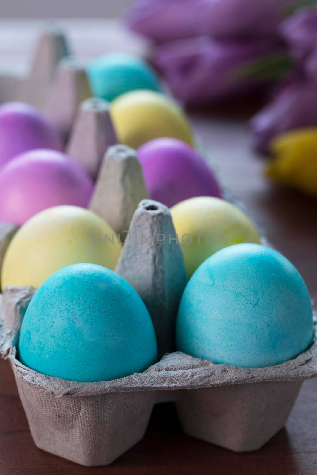 Colorful Easter eggs in egg carton.