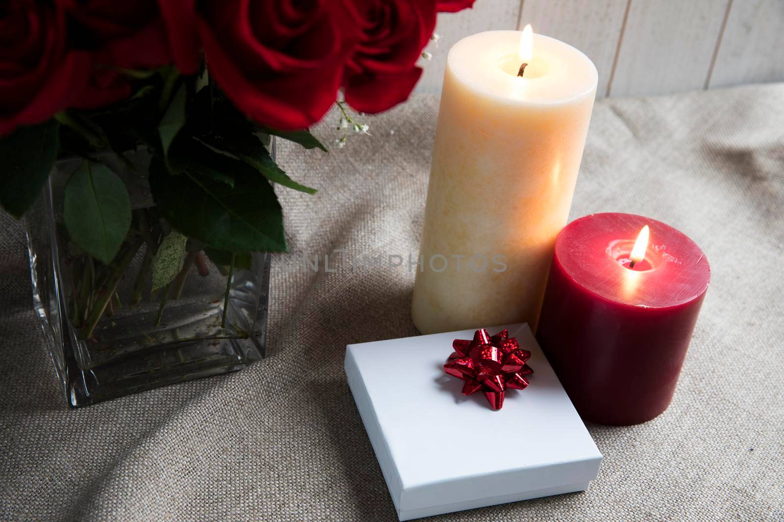 Gift box and two candles with roses