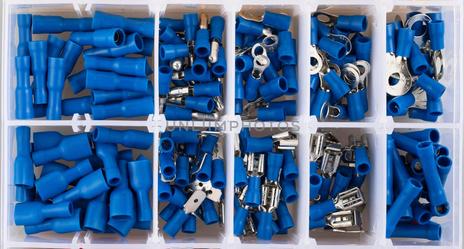 Blue electric terminal connectors organized in plastic contaner.