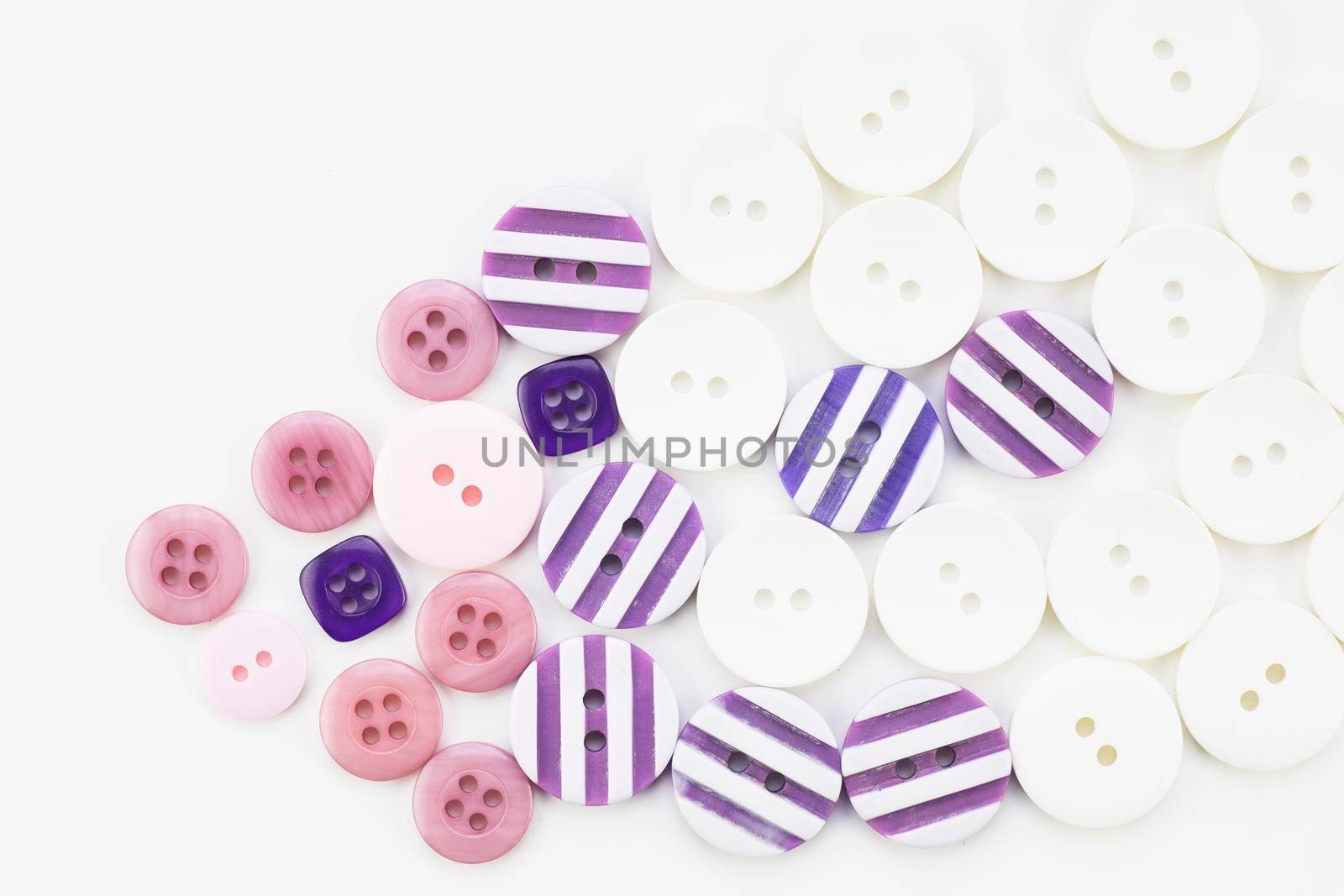 Colorful button texture with pink, purple and white buttons.