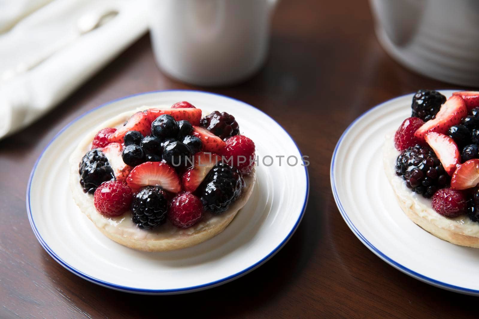 Small fruit topped tarts in on table