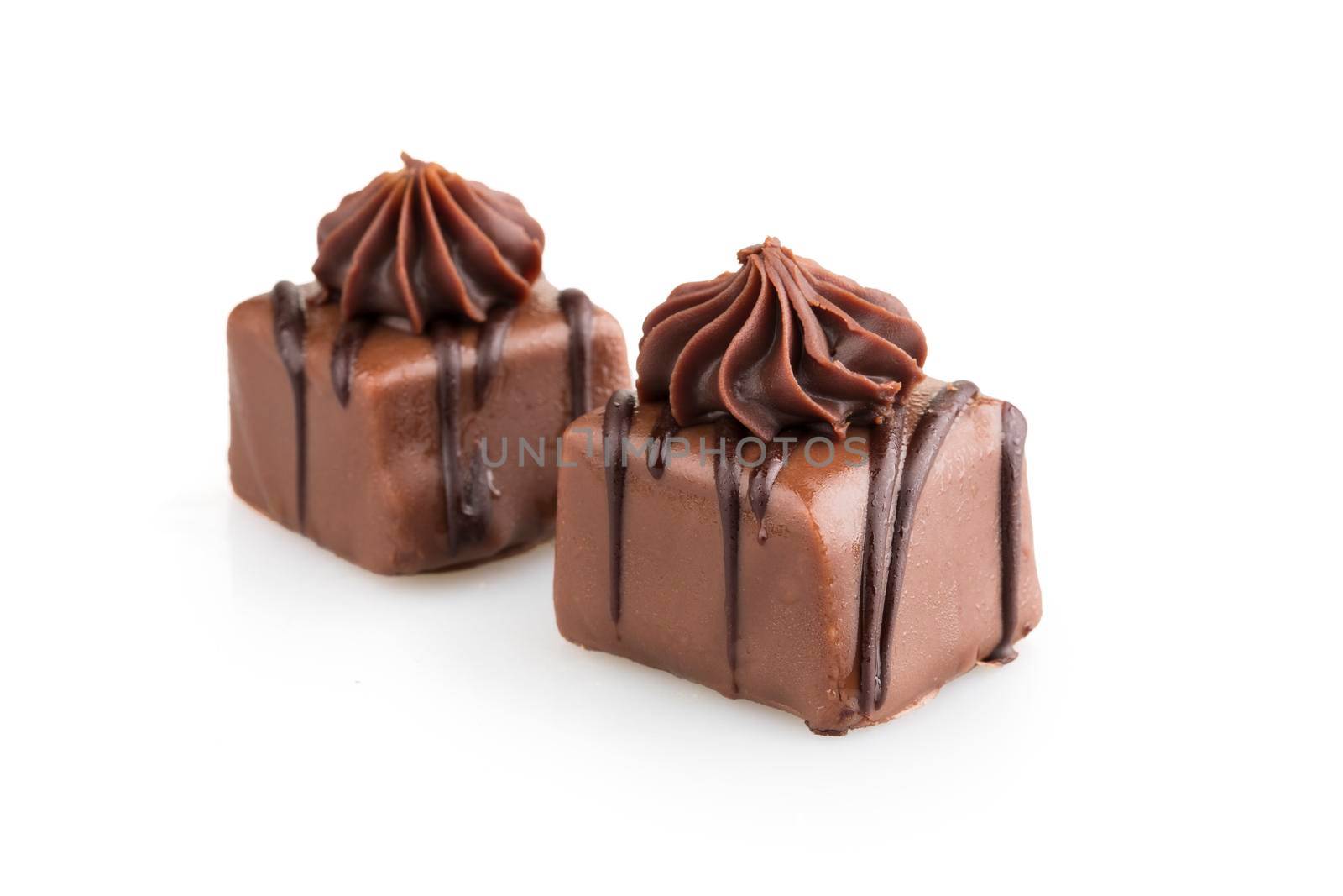 Gourmet chocolates with milk and dark chocolate isolated on white with shadow.