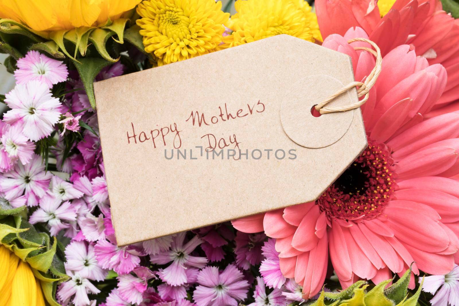 Close up of Mother's Day greeting tag on bouquet of flowers.