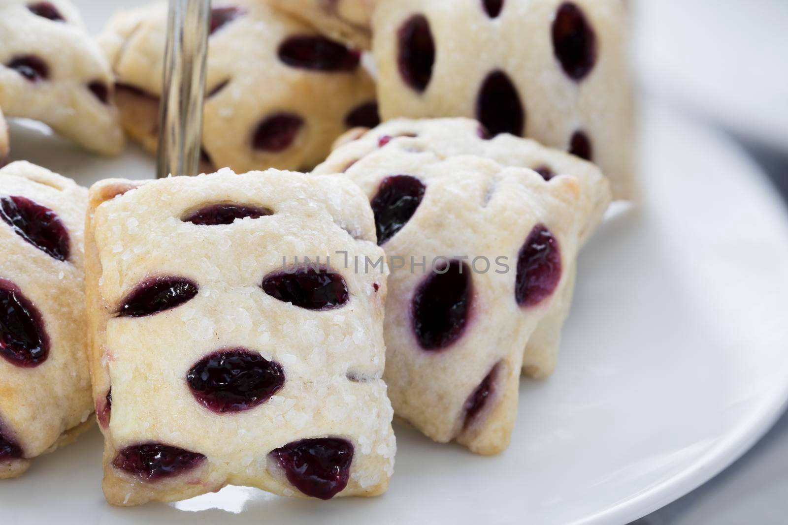 Berry filled mini strudels on a pastry stand