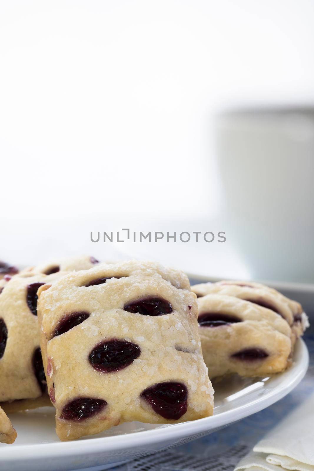 Fruit filled mini strudels with coffee cup in background and copy space.