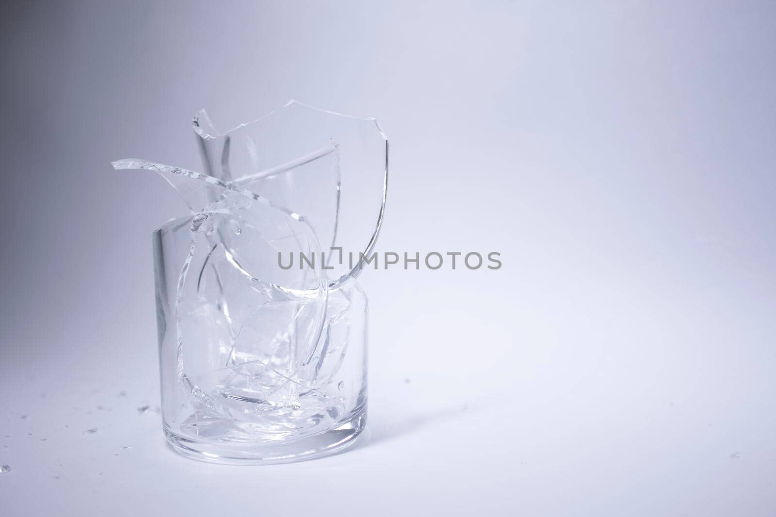 fragments of a broken glass in a broken glass on a white background. Isolated. Copy space. High quality photo