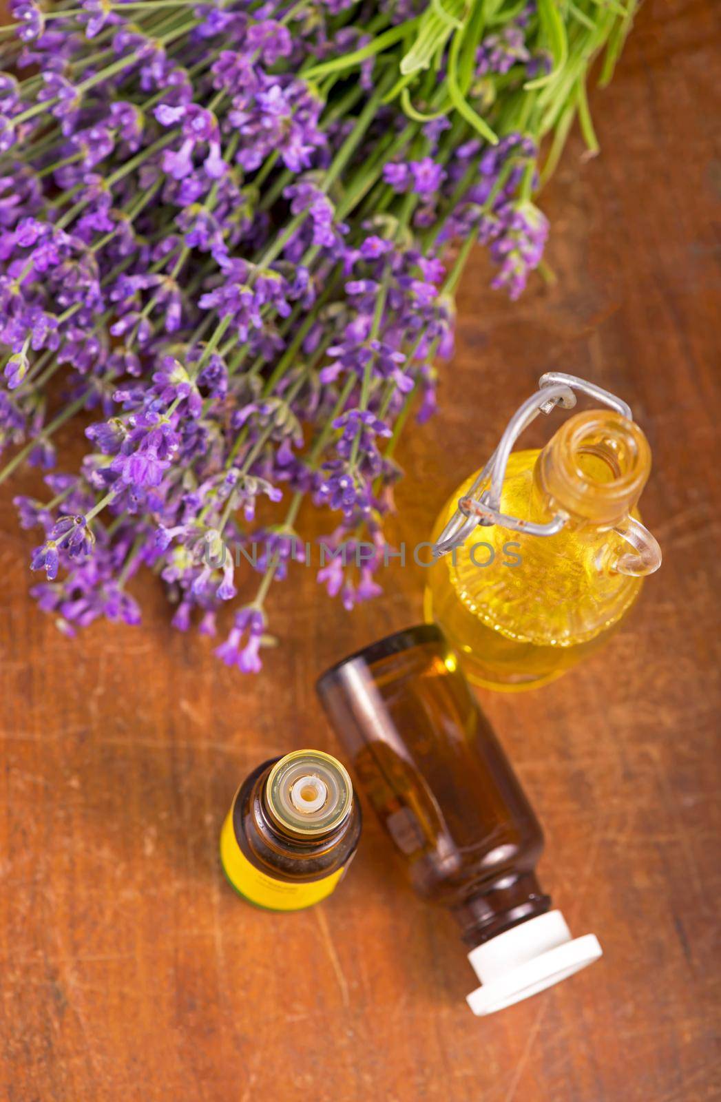 lavender oil with fresh lavender on a wooden by aprilphoto