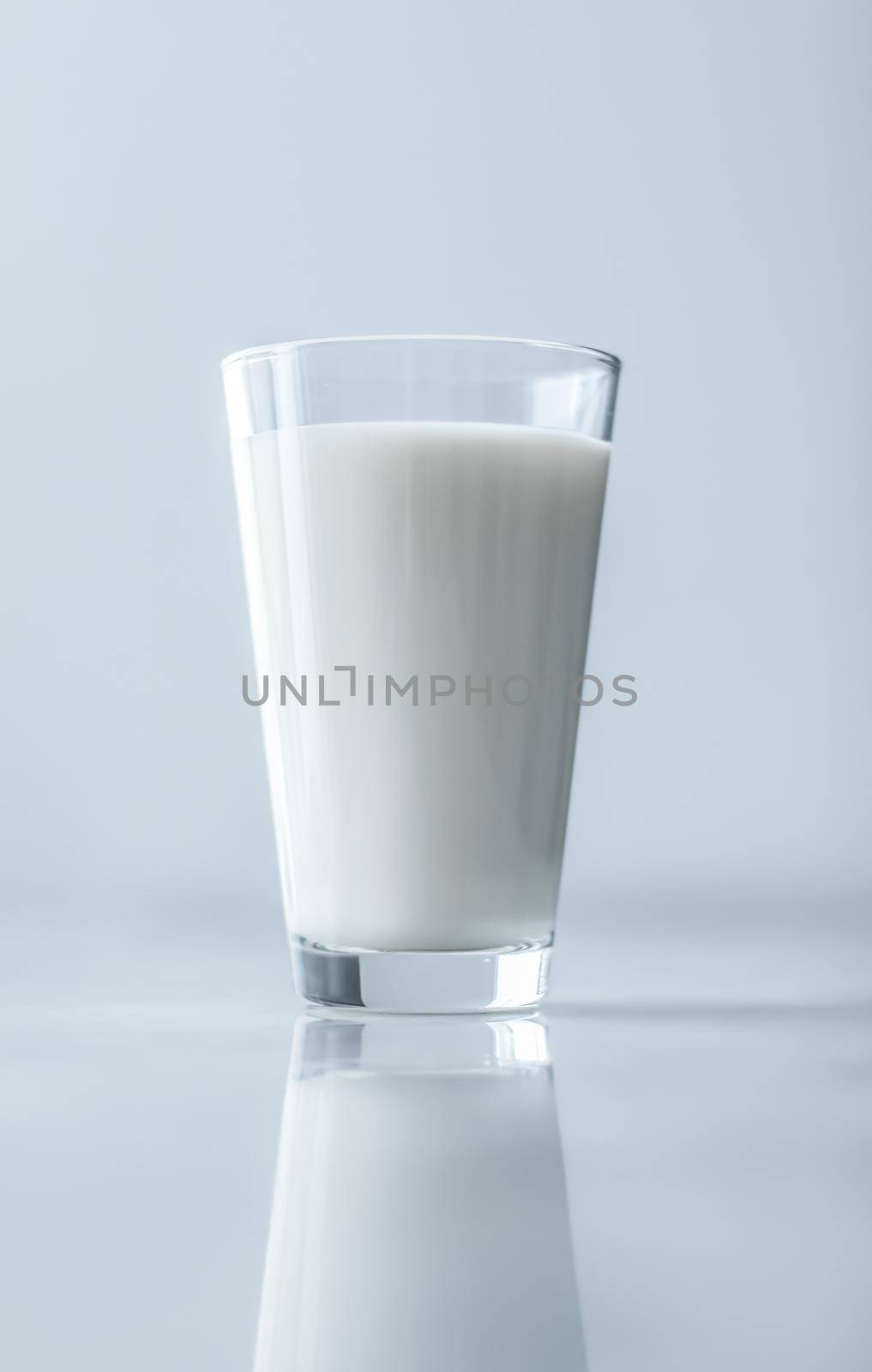 Dairy, healthy nutrition and breakfast concept - World Milk Day, full glass on marble table