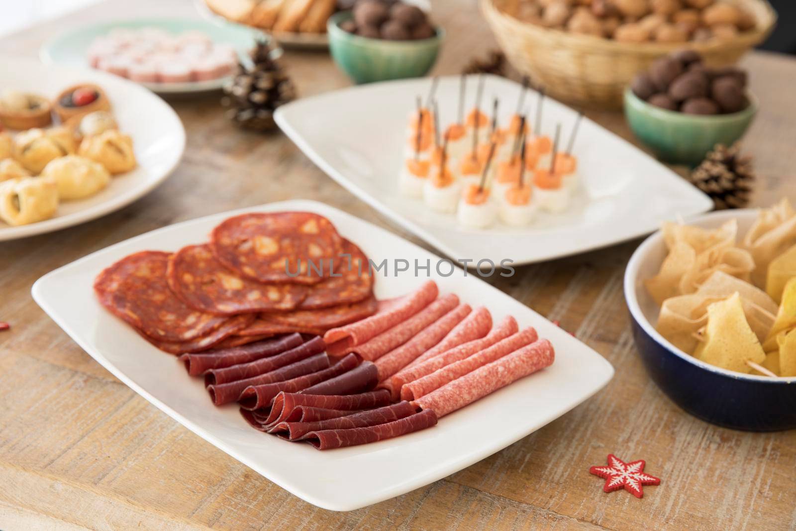 Slices of chorizo, salami and beef on buffet table.