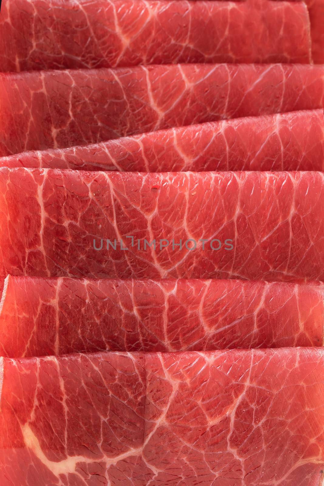 Close up of slices of bresaola, thin sliced cured beef.