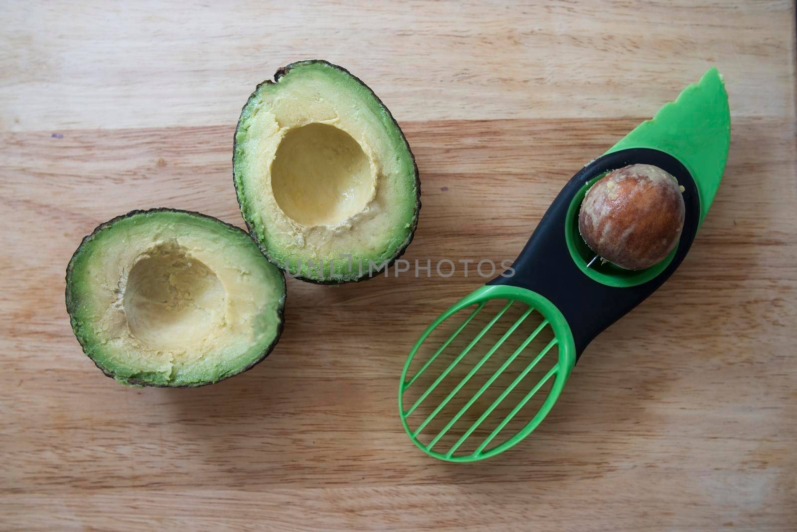 Avocado cut in half and pitted with three in one avocado preparation tool.