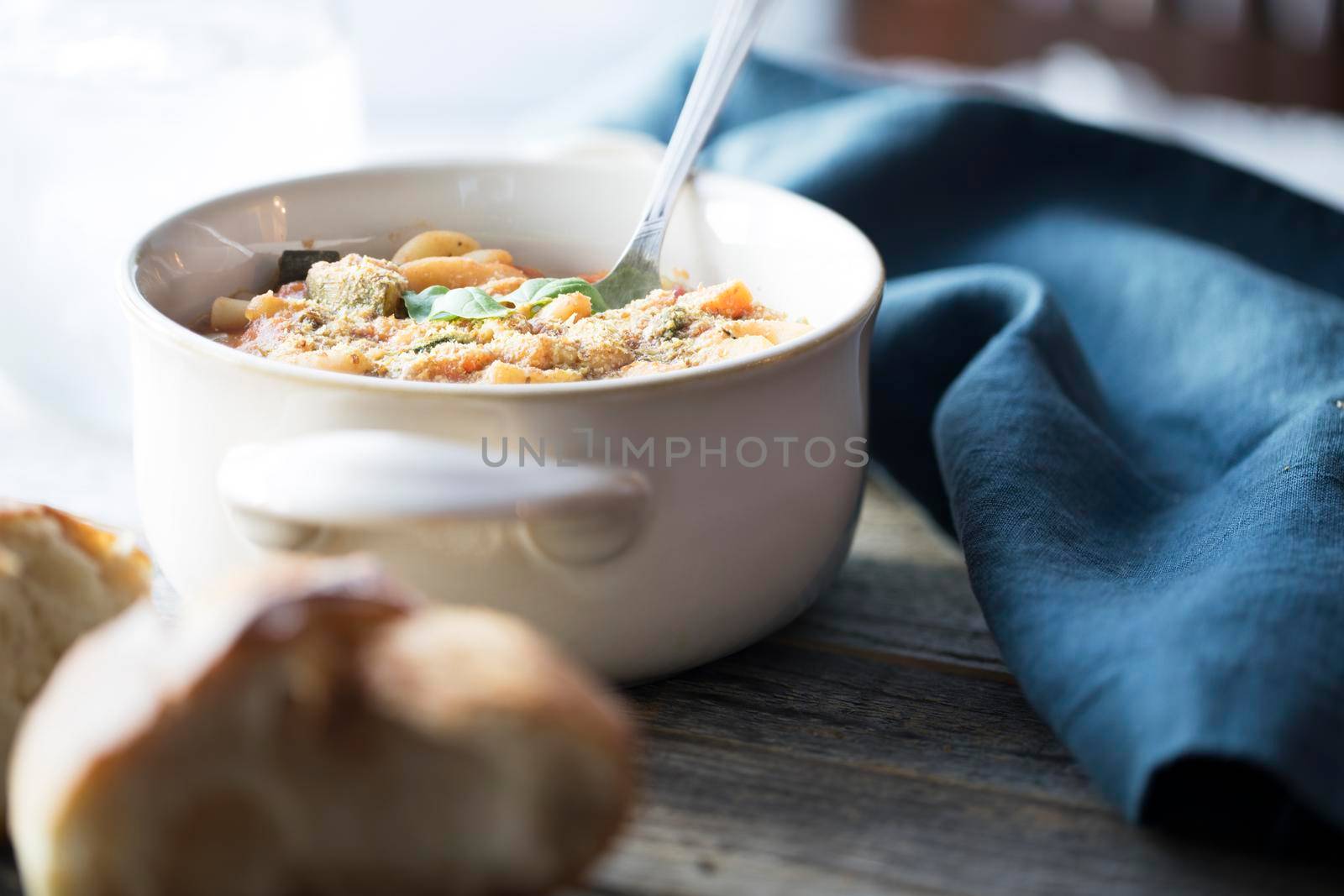 Thick and hearty vegetarian minestrone soup topped with basil