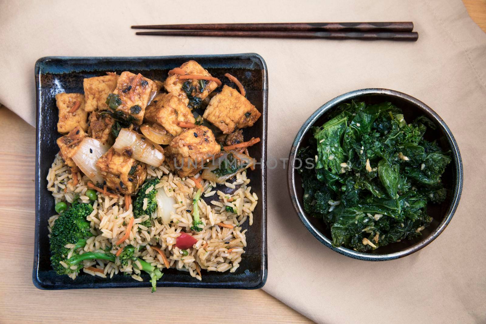 Fried tofu with rice and vegetable stir fry vegan asian meal.