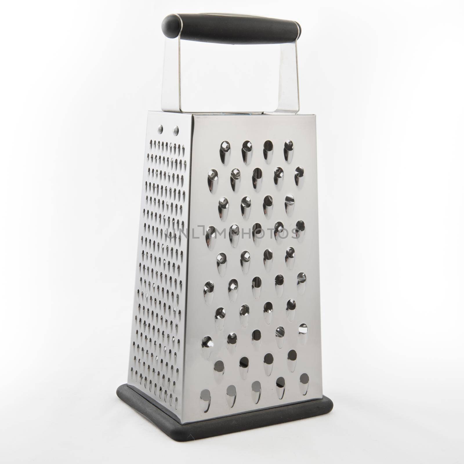 Metal cheese grater isolated on a white background, with slight shadow.