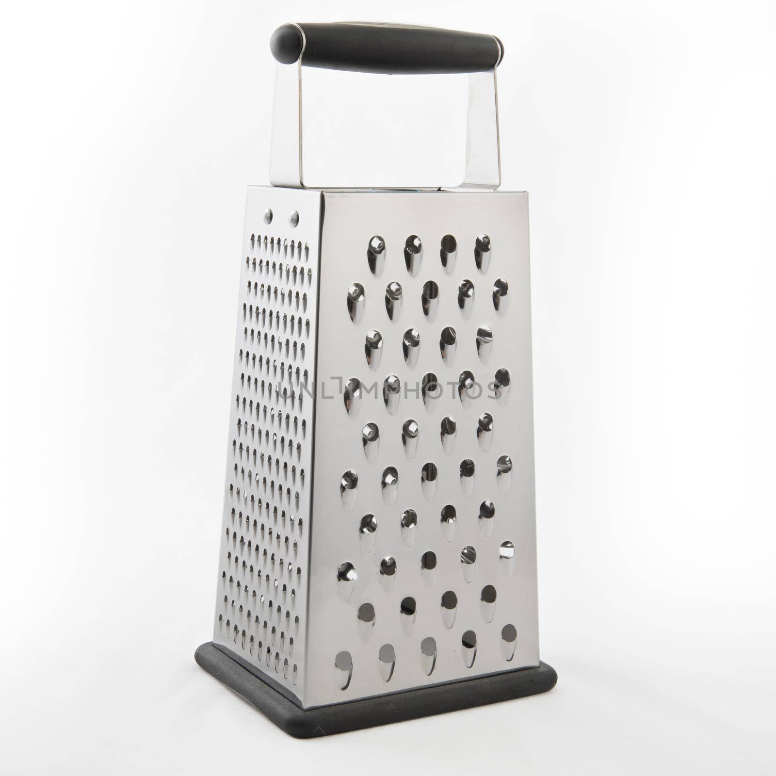 Metal cheese grater isolated on a white background, with slight shadow.