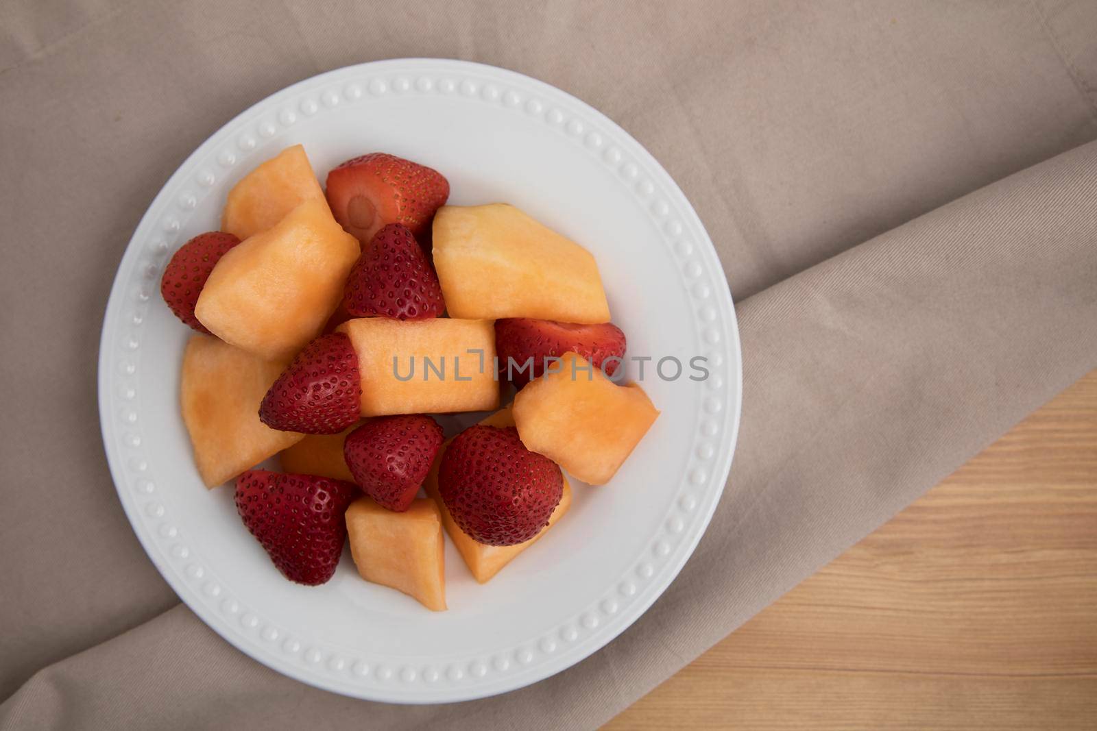 plate  of fresh strawberries and cantaloup