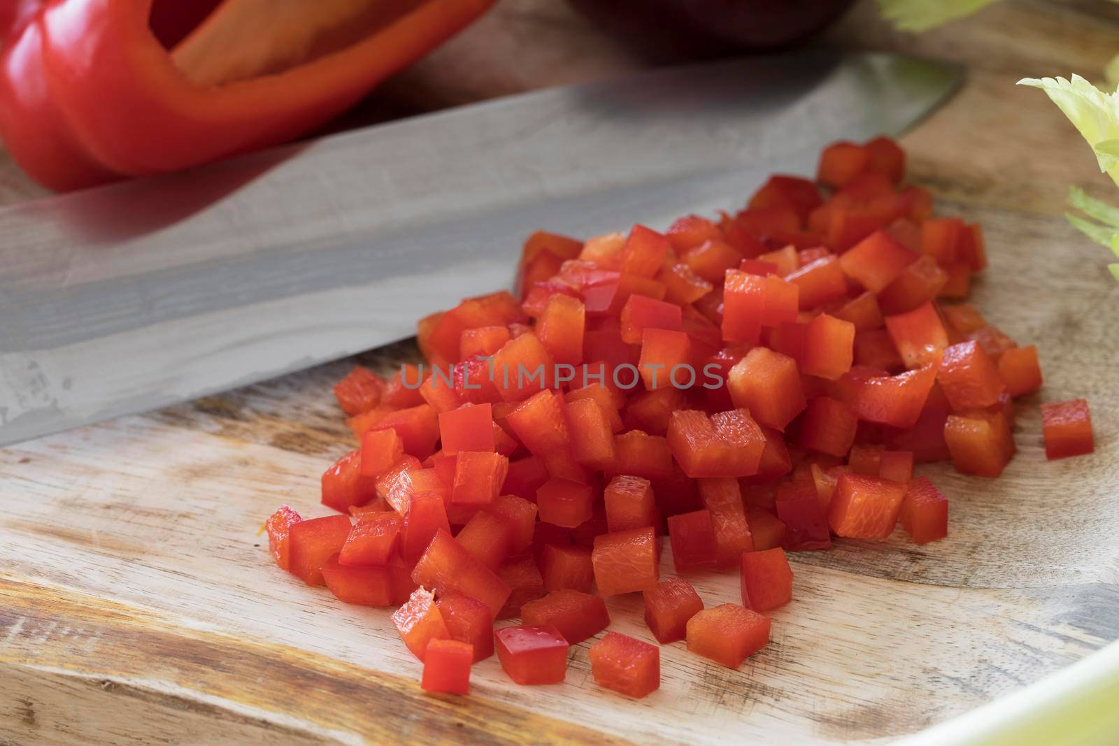 Diced red bell peppers on cutting board.