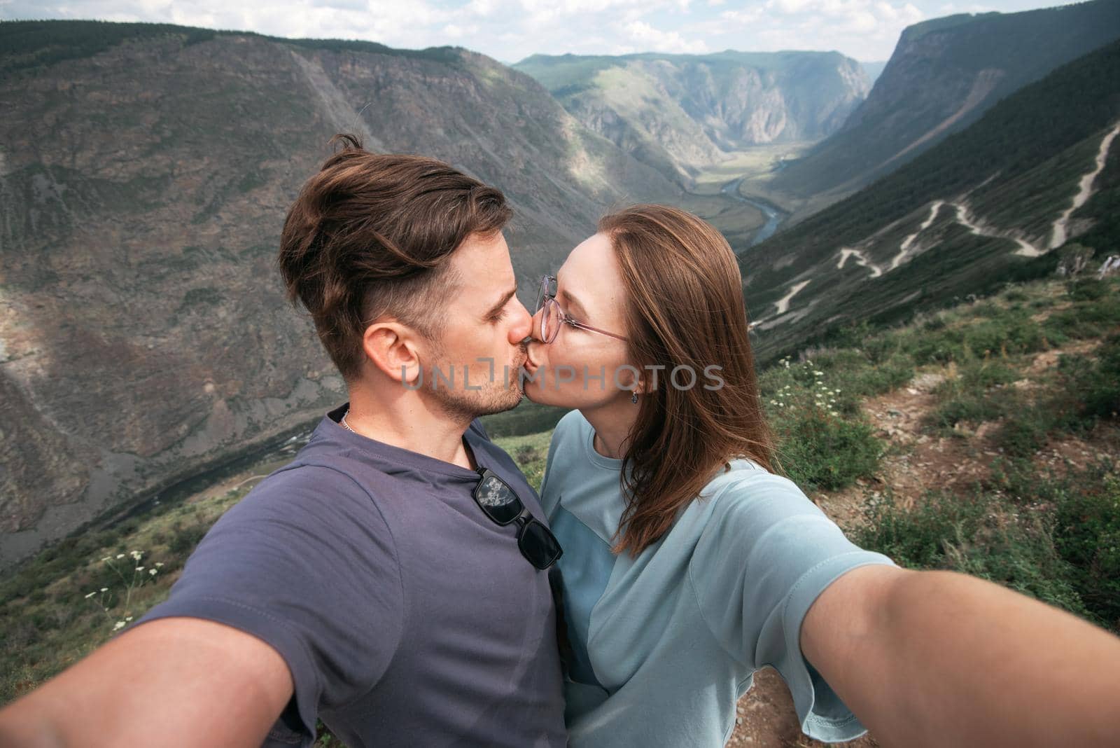 Loving couple together on Altai mountain looking at a view