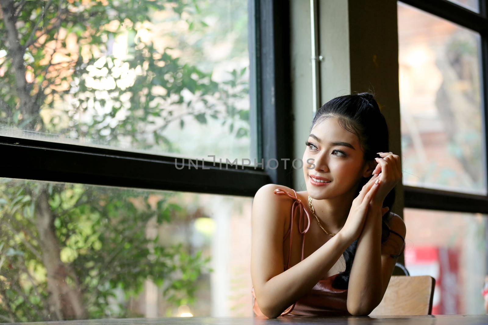 elegant sensual young woman in brown dress on recamier outdoor shot