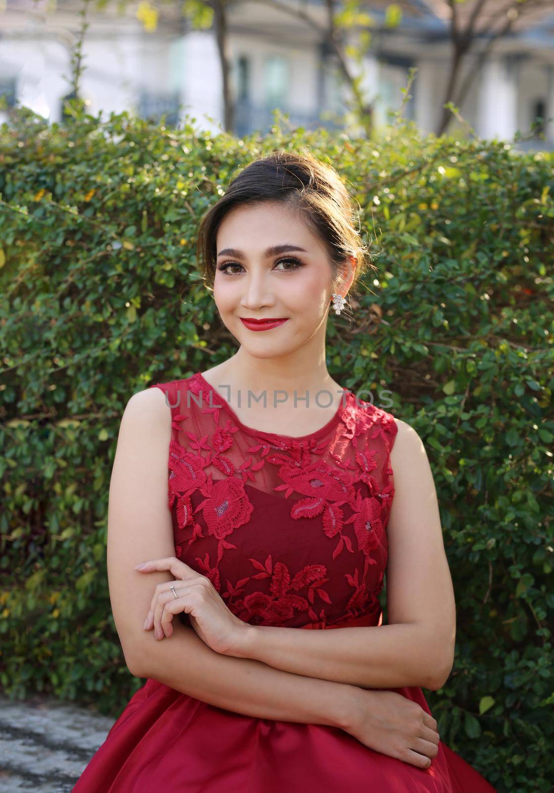 Beautiful sexy young business woman brunette hair with evening make-up wearing a red skinny dress and high-heeled shoes business clothes for meetings and walks fall collection perfect body shape. by chuanchai