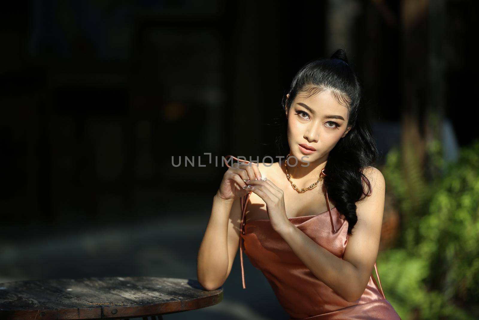 elegant sensual young woman in brown dress on recamier outdoor shot by chuanchai