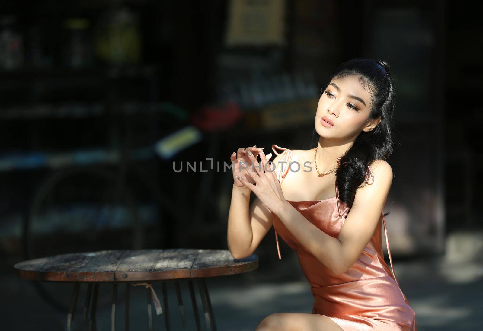 elegant sensual young woman in brown dress on recamier outdoor shot by chuanchai