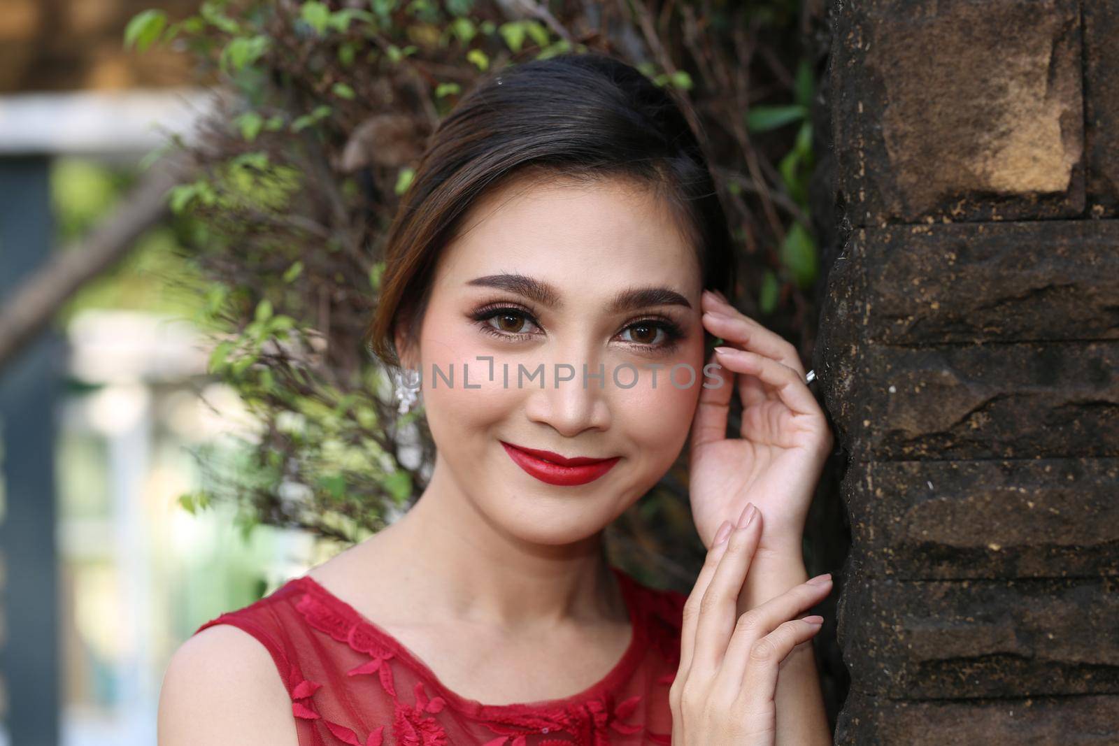 Beautiful sexy young business woman brunette hair with evening make-up wearing a red skinny dress and high-heeled shoes business clothes for meetings and walks fall collection perfect body shape. by chuanchai