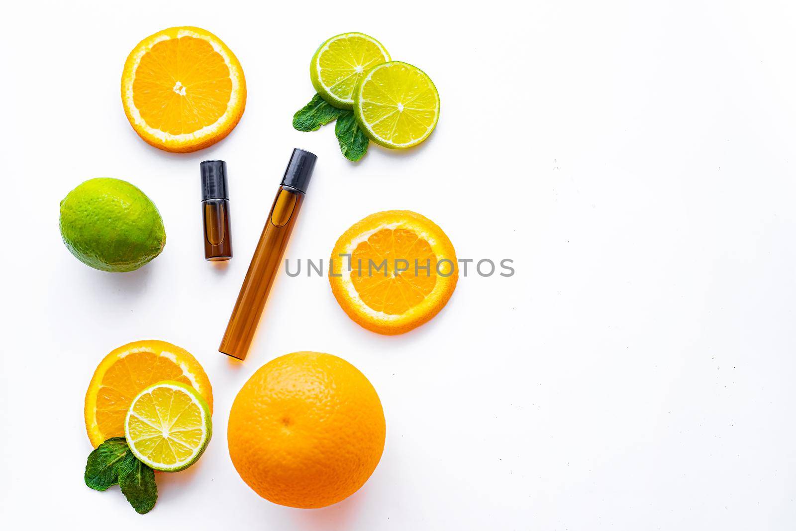 Cosmetic roller oil and citrus fruits . Cosmetic procedures. Healthy skin. Skin care. Citrus oil. White background. Copy space. Article about care cosmetics