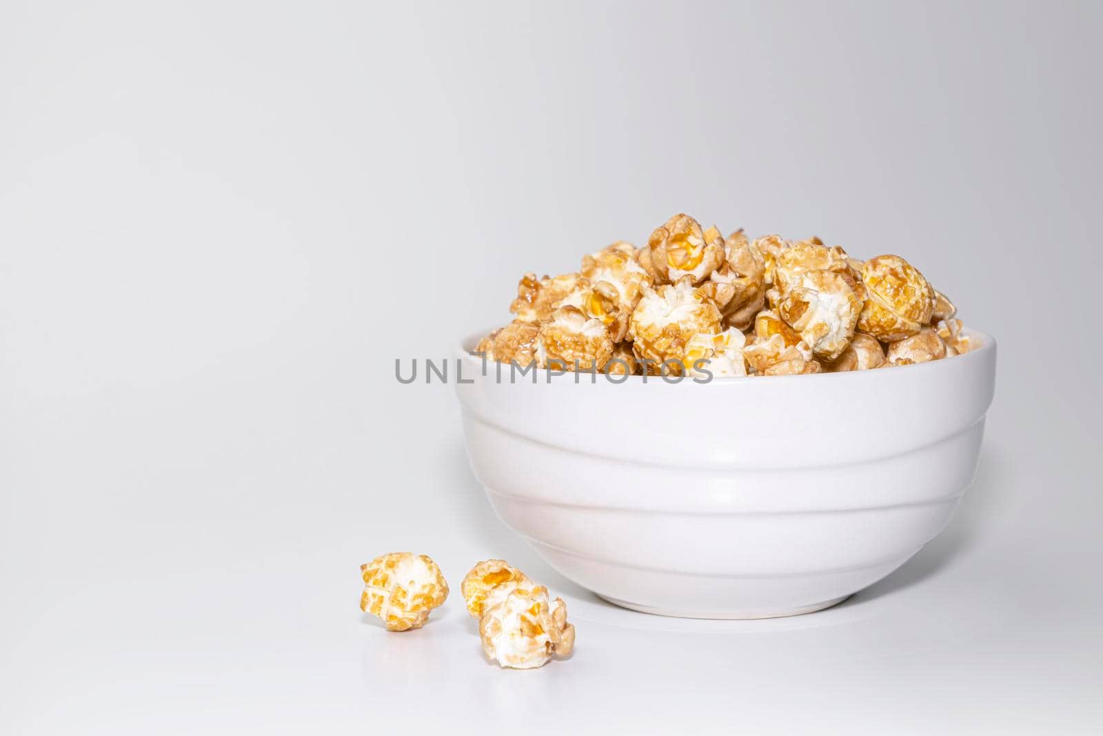 a cup of popcorn on a gray background . copy space. High quality photo