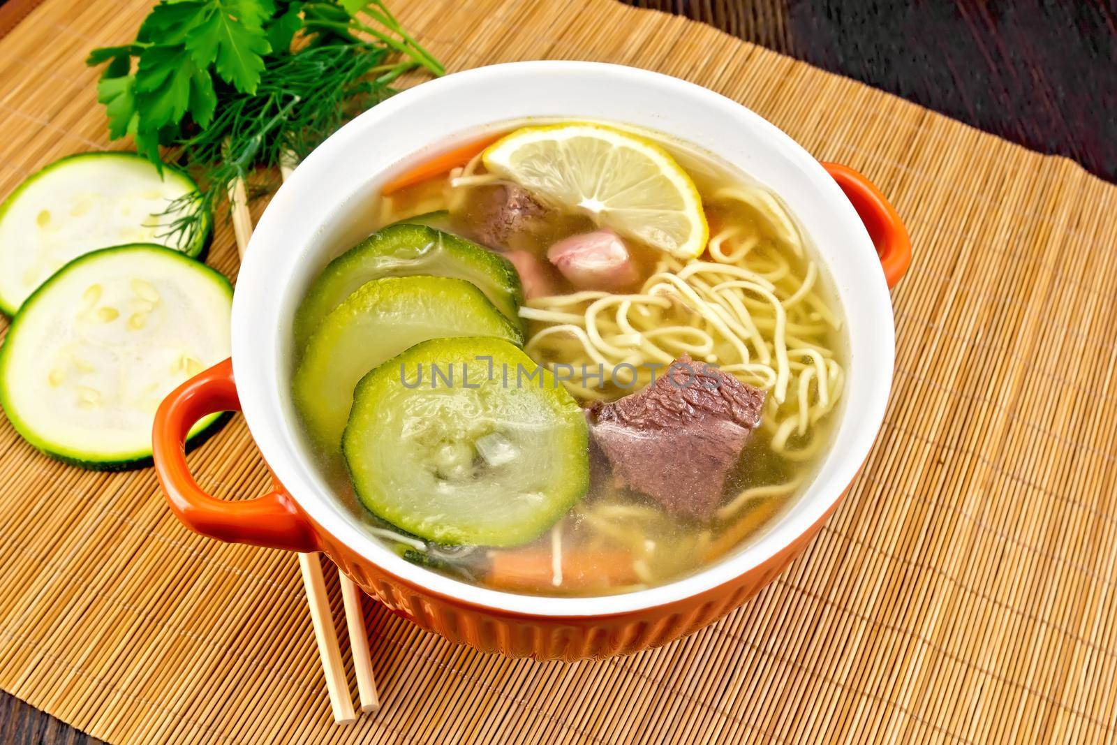 Soup with zucchini and noodles on bamboo by rezkrr