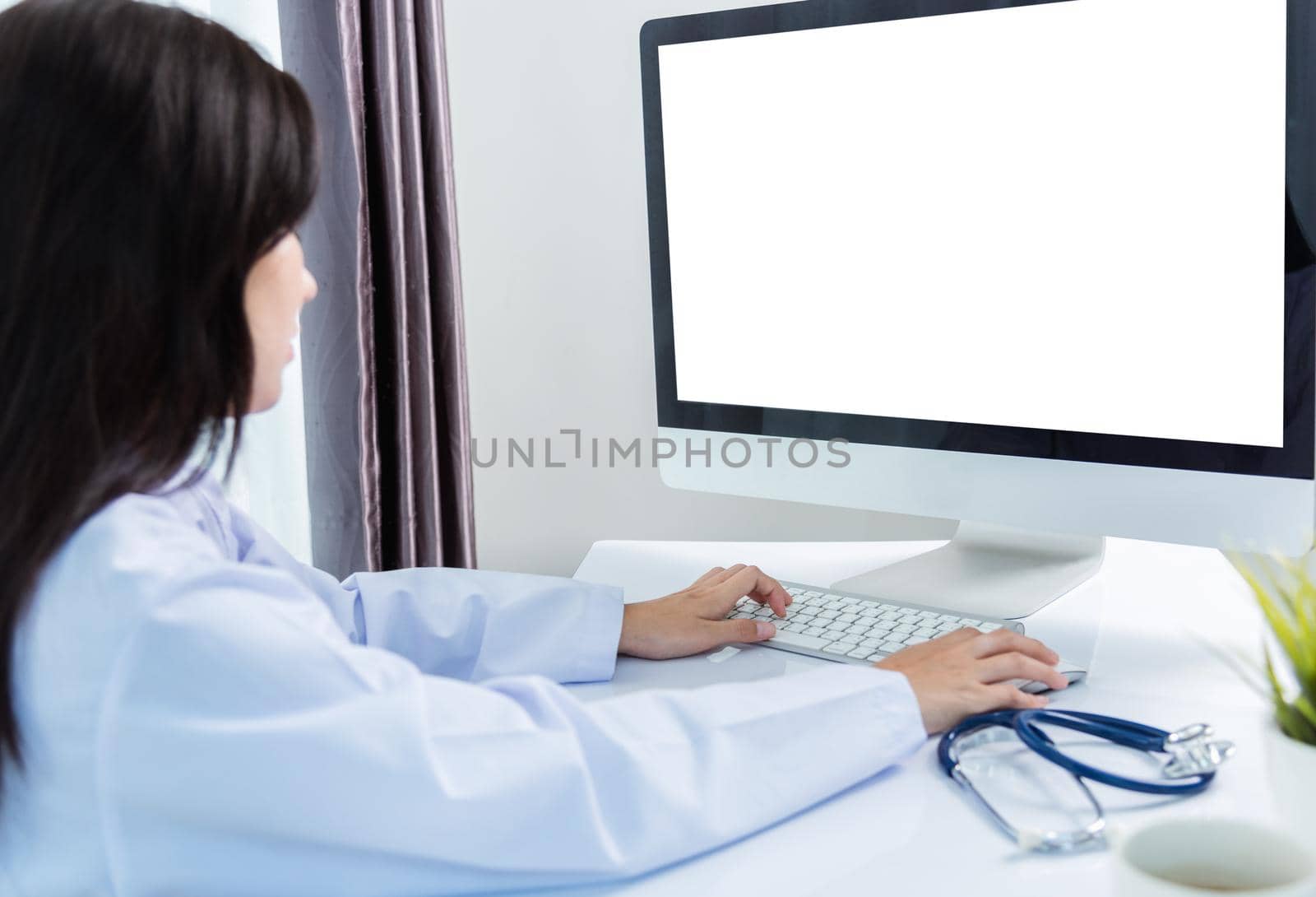 Asian young beautiful woman doctor video call conference online sit listen  patient to explain on front desktop PC computer monitor quarantines disease coronavirus or COVID-19 at hospital office