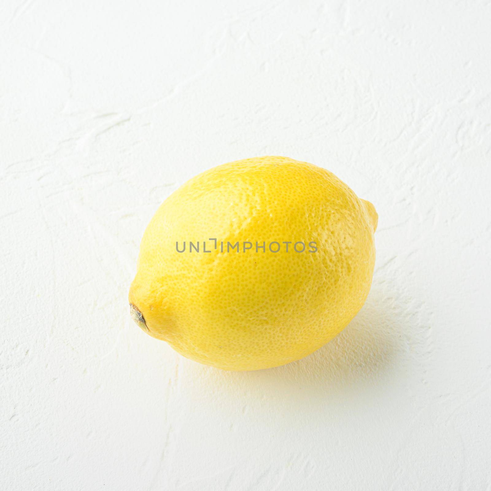 Ripe yellow lemon set, square format, on white stone background