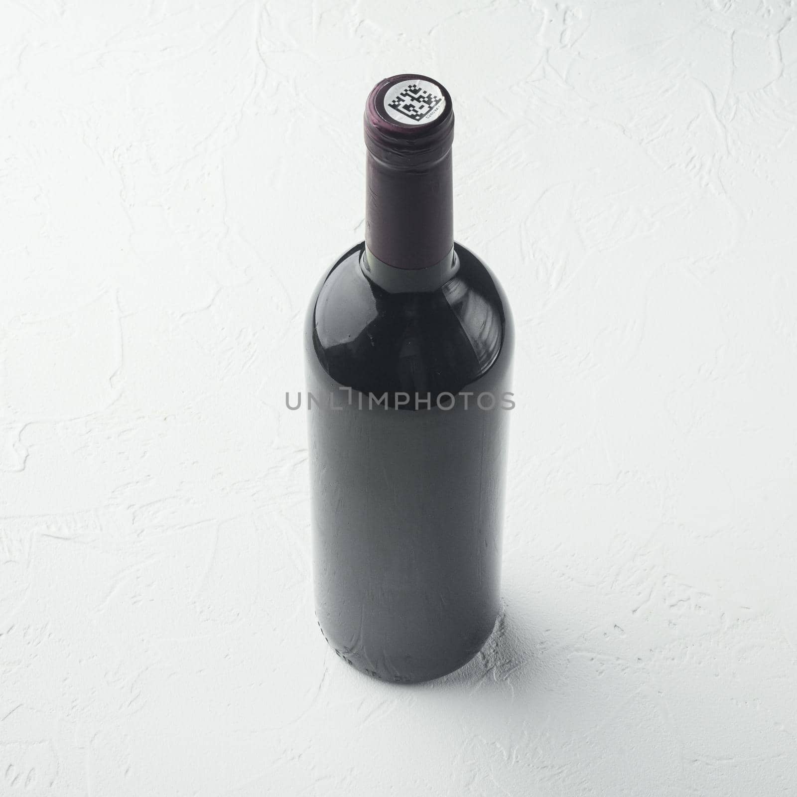 Wine bottle, square format , on white stone background by Ilianesolenyi