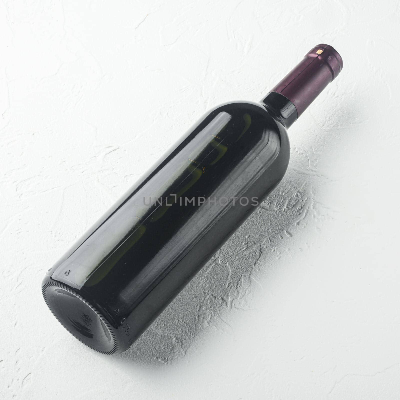 Wine bottle, square format , on white stone background by Ilianesolenyi