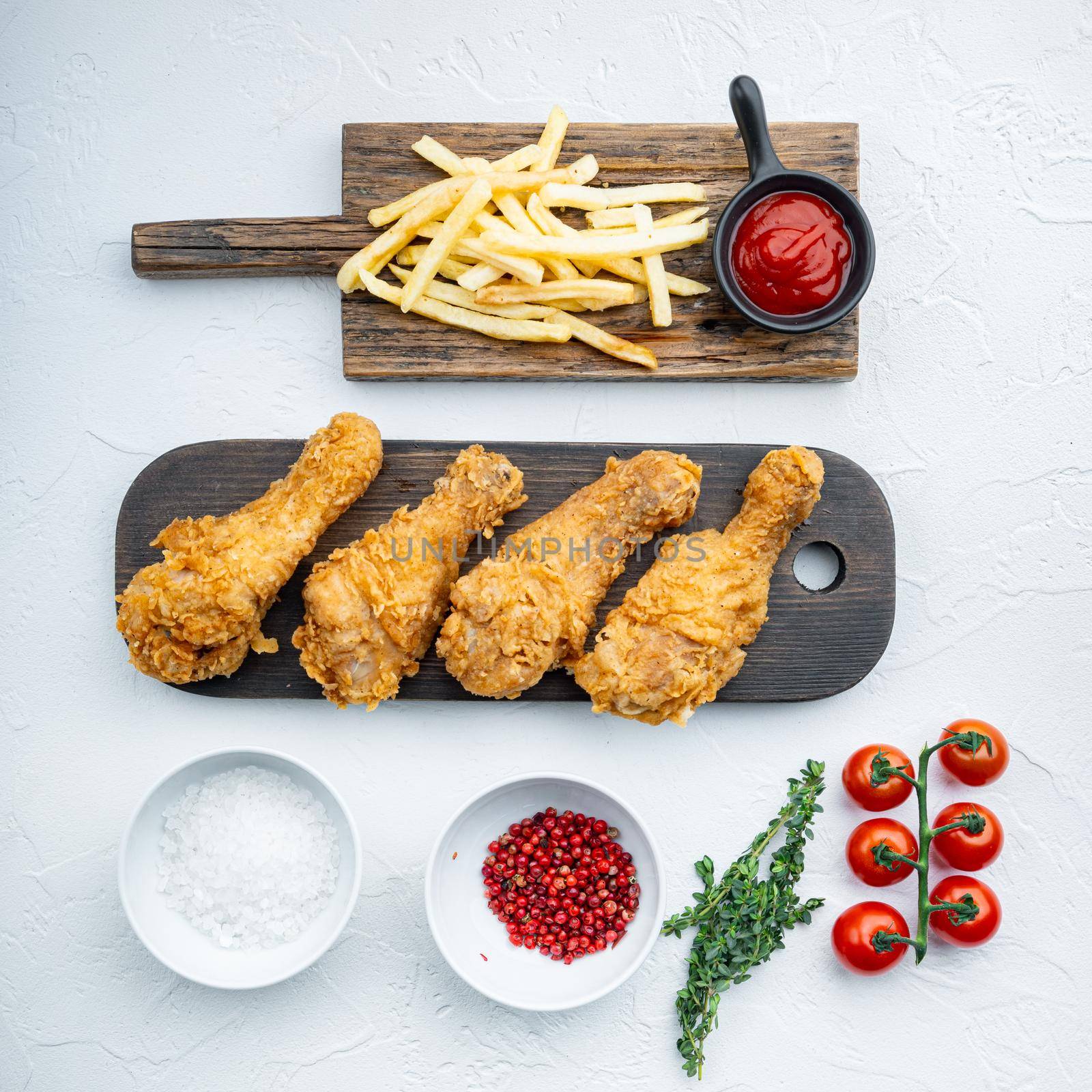 Breaded kentucky chicken drumctick on white background, flat lay by Ilianesolenyi